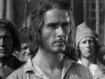 Movie still from “Captain Blood” (1935), directed by Michael Curtiz – Black and white photograph of a man with long hair; Close Up shot, Low angle