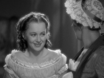Movie still from “Captain Blood” (1935), directed by Michael Curtiz – An old photo of a woman and a man; Close Up shot, Over the shoulder angle
