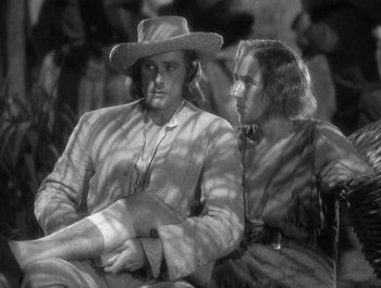 Movie still from “Captain Blood” (1935), directed by Michael Curtiz – A man and a woman sitting next to each other; Medium shot, Low angle