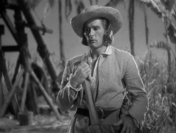 Movie still from “Captain Blood” (1935), directed by Michael Curtiz – A black and white photo of a man in a straw hat; Medium shot, Low angle