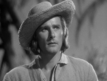 Movie still from “Captain Blood” (1935), directed by Michael Curtiz – A black and white photo of a man wearing a straw hat; Close Up shot, Low angle