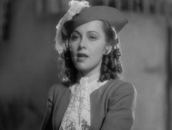 Movie still from “Captain Blood” (1935), directed by Michael Curtiz – An old photo of a woman wearing a hat; Close Up shot, Low angle