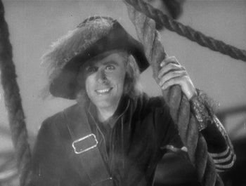 Movie still from “Captain Blood” (1935), directed by Michael Curtiz – A black and white photo of a man wearing a pirate's hat; Medium shot, Low angle