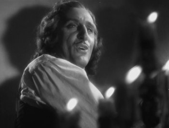 Movie still from “Captain Blood” (1935), directed by Michael Curtiz – An old photo of a man with a scarf around his neck; Close Up shot, Low angle