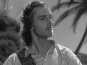 Movie still from “Captain Blood” (1935), directed by Michael Curtiz – Black and white photograph of a man with long curly hair; Close Up shot, Low angle