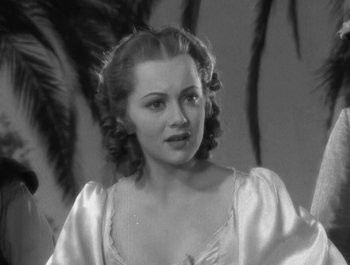 Movie still from “Captain Blood” (1935), directed by Michael Curtiz – A black - and - white photo of a woman in a white dress; Close Up shot, Low angle