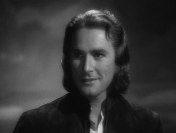 Movie still from “Captain Blood” (1935), directed by Michael Curtiz – A black and white photo of a man with long hair; Close Up shot, Low angle