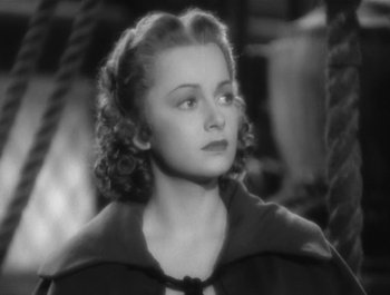 Movie still from “Captain Blood” (1935), directed by Michael Curtiz – A black - and - white photo of a woman with curly hair; Close Up shot, High angle