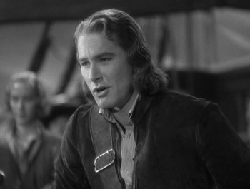 Movie still from “Captain Blood” (1935), directed by Michael Curtiz – Black and white photograph of a man with long hair; Close Up shot, Over the shoulder angle
