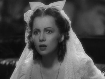 Movie still from “Captain Blood” (1935), directed by Michael Curtiz – A black and white photo of a woman wearing a wedding veil; Close Up shot, High angle