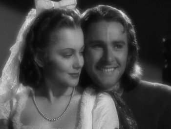 Movie still from “Captain Blood” (1935), directed by Michael Curtiz – A man and a woman posing for a picture; Close Up shot, Low angle