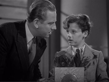 Movie still from “Captains Courageous” (1937), directed by Victor Fleming – An older man and a young boy looking at each other; Medium shot, High angle