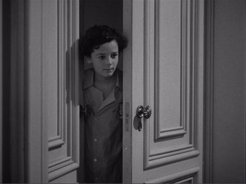 Movie still from “Captains Courageous” (1937), directed by Victor Fleming – A little girl standing in a door way looking out; Medium shot, High angle