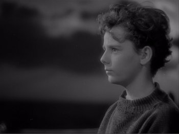 Movie still from “Captains Courageous” (1937), directed by Victor Fleming – A young boy is looking off into the distance; Close Up shot, High angle