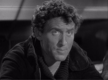 Movie still from “Captains Courageous” (1937), directed by Victor Fleming – A man with curly red hair is looking at the camera; Close Up shot, High angle