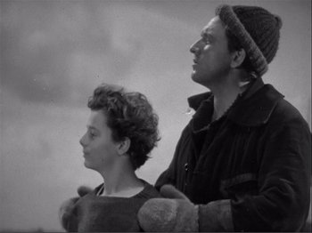 Movie still from “Captains Courageous” (1937), directed by Victor Fleming – A man and a woman standing next to each other; Medium shot, Low angle