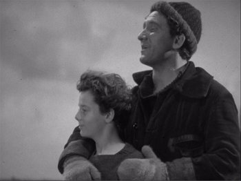Movie still from “Captains Courageous” (1937), directed by Victor Fleming – A man and a woman standing next to each other; Medium shot, Low angle