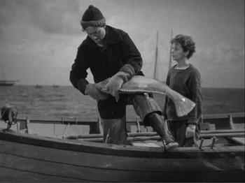 Movie still from “Captains Courageous” (1937), directed by Victor Fleming – An old photo of a man and a boy fishing; Medium shot, High angle