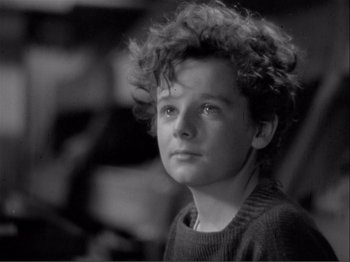 Movie still from “Captains Courageous” (1937), directed by Victor Fleming – Black and white photograph of a young man with curly hair; Close Up shot, High angle