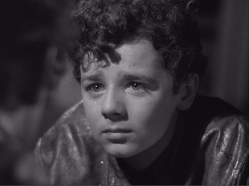 Movie still from “Captains Courageous” (1937), directed by Victor Fleming – A young boy with a tear in his eye; Close Up shot, High angle