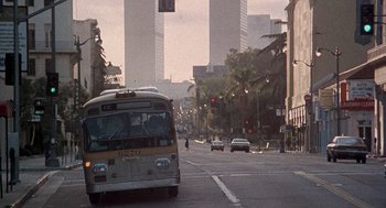 Movie still from “Car Wash” (1976), directed by Michael Schultz – A bus is driving down the street in a city; Extreme Wide shot, Low angle