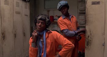 Movie still from “Car Wash” (1976), directed by Michael Schultz – A man and a woman standing next to each other; Medium shot, Low angle