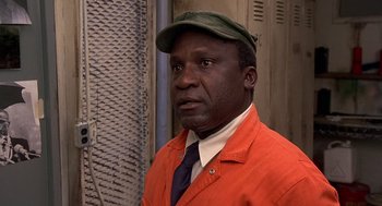 Movie still from “Car Wash” (1976), directed by Michael Schultz – A man in an orange jacket and a green hat; Close Up shot, Low angle