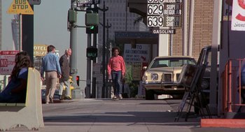 Movie still from “Car Wash” (1976), directed by Michael Schultz – A man riding a skateboard down the middle of a street; Wide shot, Low angle