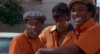 Movie still from “Car Wash” (1976), directed by Michael Schultz – A group of men standing next to each other; Close Up shot, Low angle