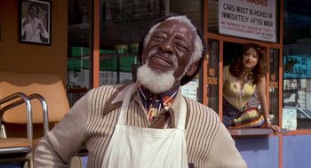 Movie still from “Car Wash” (1976), directed by Michael Schultz – An older man with a beard and a white beard; Medium shot, Low angle