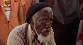 Movie still from “Car Wash” (1976), directed by Michael Schultz – An old man with a beard and a black hat; Close Up shot, High angle