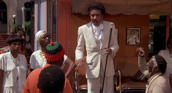 Movie still from “Car Wash” (1976), directed by Michael Schultz – A group of people standing next to each other in a room; Medium shot, Low angle