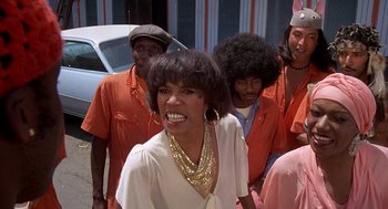 Movie still from “Car Wash” (1976), directed by Michael Schultz – A group of people standing next to each other on the street; Close Up shot, Low angle