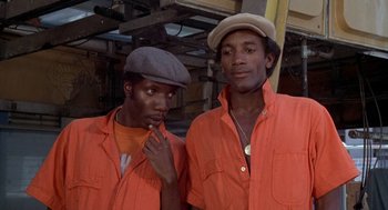 Movie still from “Car Wash” (1976), directed by Michael Schultz – A couple of men standing next to each other; Close Up shot, Low angle