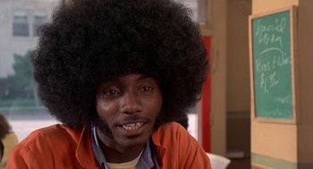 Movie still from “Car Wash” (1976), directed by Michael Schultz – A man with a large afro sitting in a room; Close Up shot, Low angle