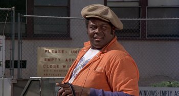 Movie still from “Car Wash” (1976), directed by Michael Schultz – A man wearing an orange jacket and a hat; Close Up shot, Low angle