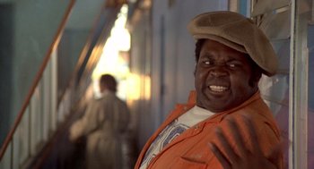 Movie still from “Car Wash” (1976), directed by Michael Schultz – A man in an orange jacket and a brown hat; Close Up shot, Low angle