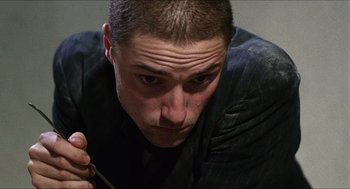 Movie still from “Caravaggio” (1986), directed by Derek Jarman – A person holding a pencil; Close Up shot, Low angle