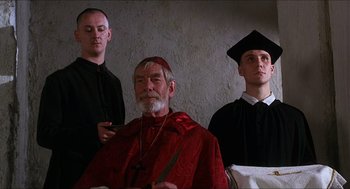 Movie still from “Caravaggio” (1986), directed by Derek Jarman – A group of men standing next to each other in a room; Medium shot, Low angle