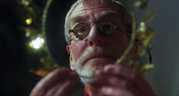 Movie still from “Caravaggio” (1986), directed by Derek Jarman – An older man with glasses looking at himself in a mirror; Close Up shot, Low angle