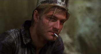 Movie still from “Caravaggio” (1986), directed by Derek Jarman – A person with a cigarette in his mouth; Close Up shot, Low angle