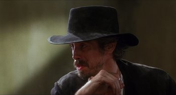 Movie still from “Caravaggio” (1986), directed by Derek Jarman – A person wearing a hat; Close Up shot, Low angle