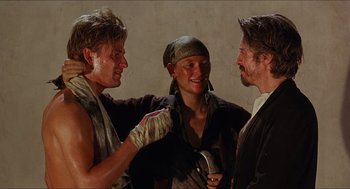 Movie still from “Caravaggio” (1986), directed by Derek Jarman – A group of people standing next to each other; Medium shot, Over the shoulder angle