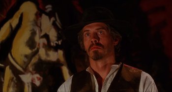 Movie still from “Caravaggio” (1986), directed by Derek Jarman – A person wearing a hat; Close Up shot, Low angle