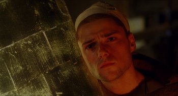 Movie still from “Caravaggio” (1986), directed by Derek Jarman – A person wearing a hat; Close Up shot, Low angle