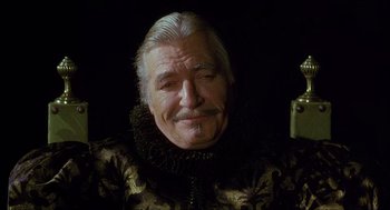 Movie still from “Caravaggio” (1986), directed by Derek Jarman – An older man with a beard and mustache; Close Up shot, High angle