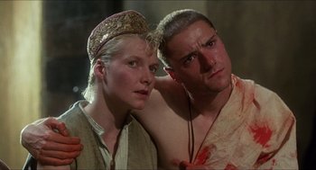 Movie still from “Caravaggio” (1986), directed by Derek Jarman – A man and a woman standing next to each other; Close Up shot, Low angle