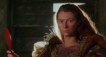 Movie still from “Caravaggio” (1986), directed by Derek Jarman – A person wearing a dress; Close Up shot, Low angle