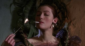 Movie still from “Caravaggio” (1986), directed by Derek Jarman – A woman is smoking a cigarette in the dark; Close Up shot, Low angle