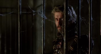 Movie still from “Caravaggio” (1986), directed by Derek Jarman – A person behind a fence; Close Up shot, Low angle